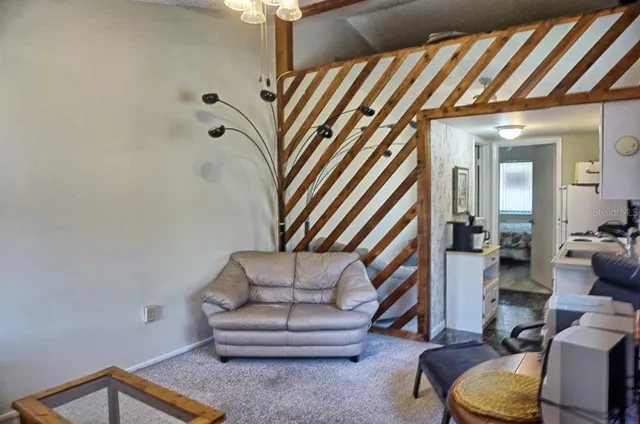 a living room with furniture and a stairs