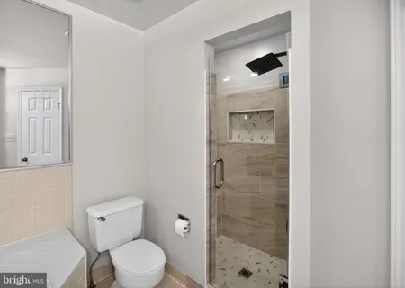 a bathroom with a toilet a sink and shower