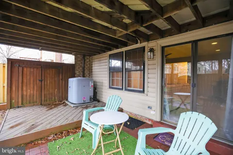 a view of a patio with table and chairs and potted plants