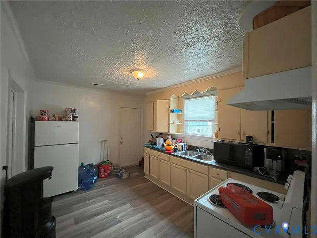 a kitchen with a refrigerator and a stove