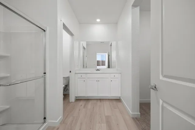 a bathroom with a sink a mirror and a shower