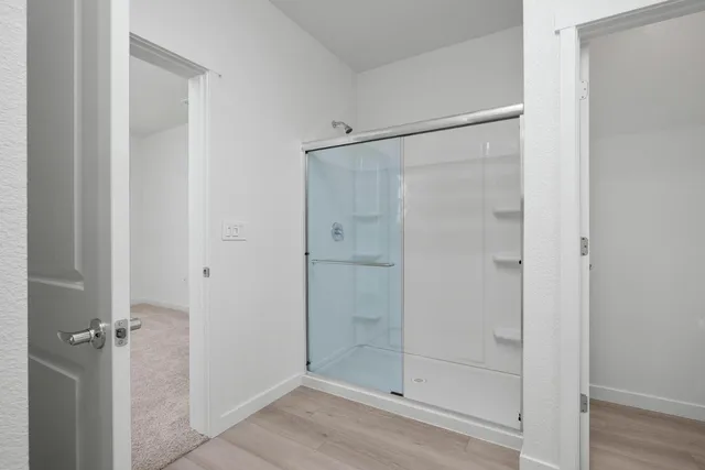 a bathroom with a glass shower door