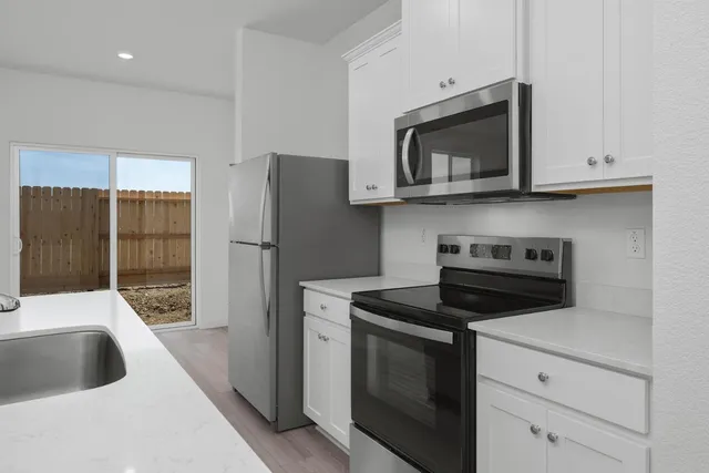 a kitchen with a stove and a microwave