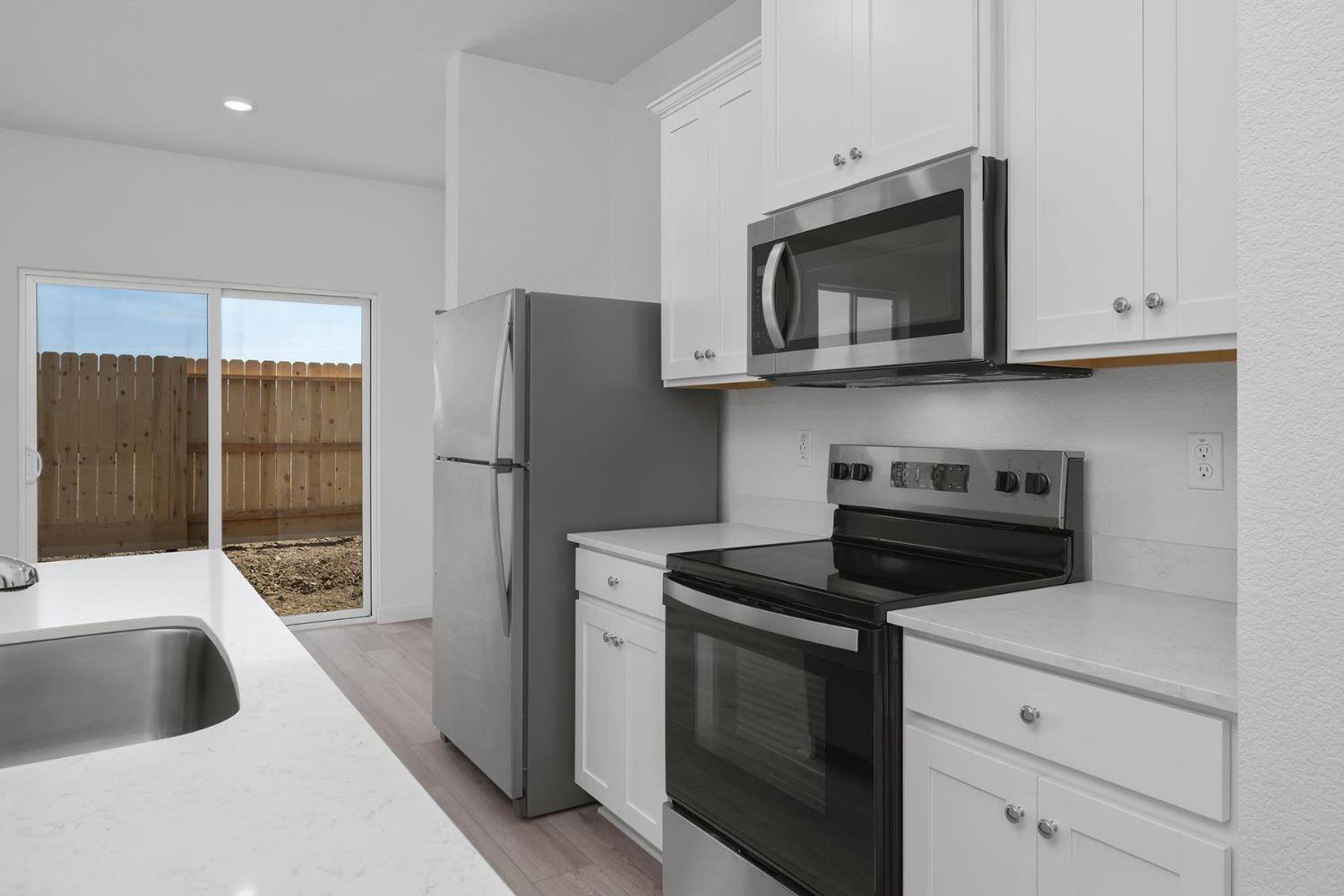 812 Chatham Lane Patterson, CA 95363 - Photo 5 of 16 a kitchen with a stove and a microwave