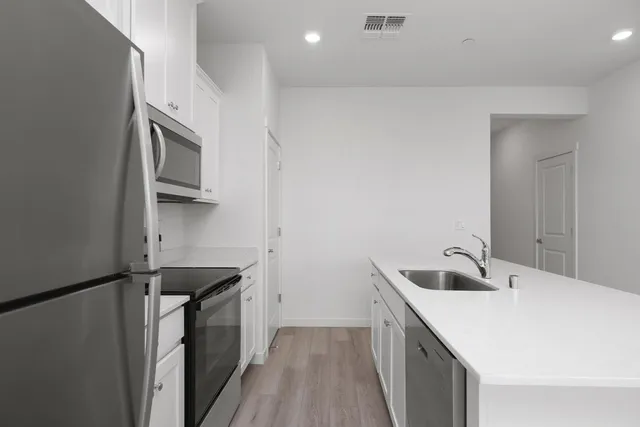 a kitchen with a sink and a refrigerator