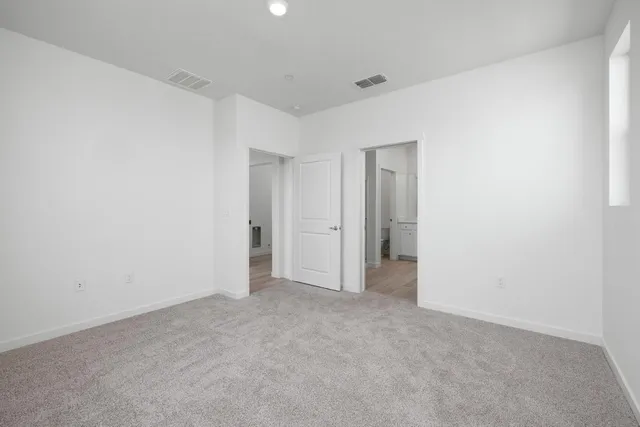 a view of an empty room and closet area