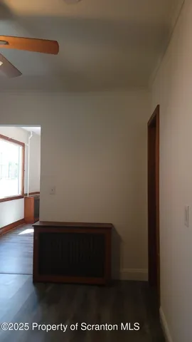 a room with wooden floor and windows