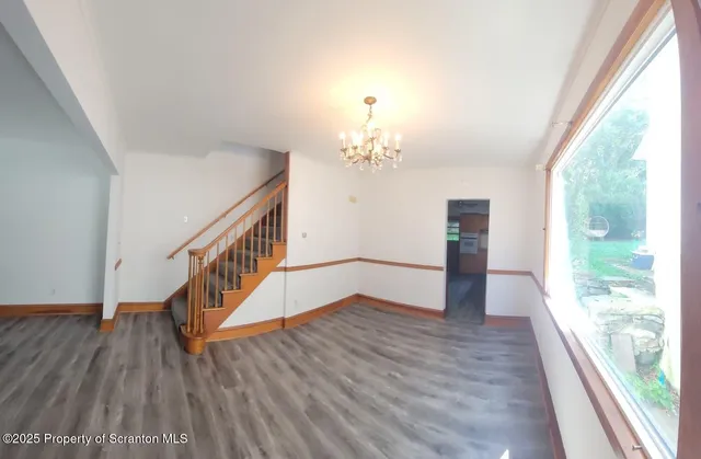 a view of entryway with wooden floor