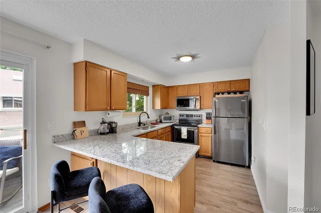 a kitchen with refrigerator and cabinets