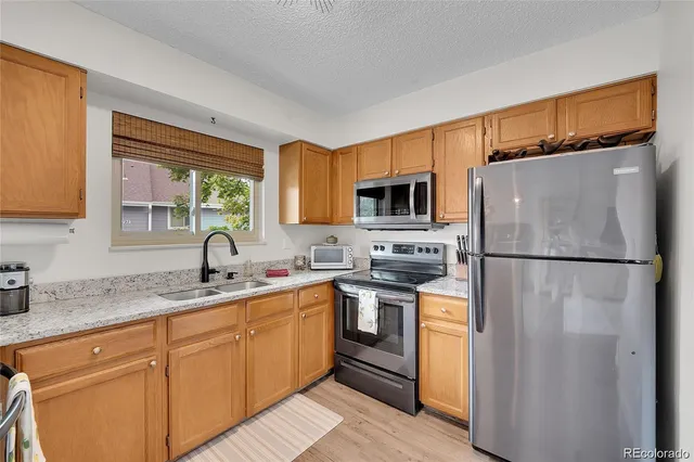 a kitchen with a refrigerator sink and microwave