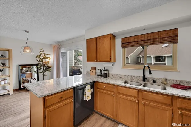 a kitchen with a sink cabinets and wooden floor