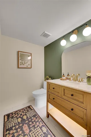 a bathroom with a toilet a sink and mirror