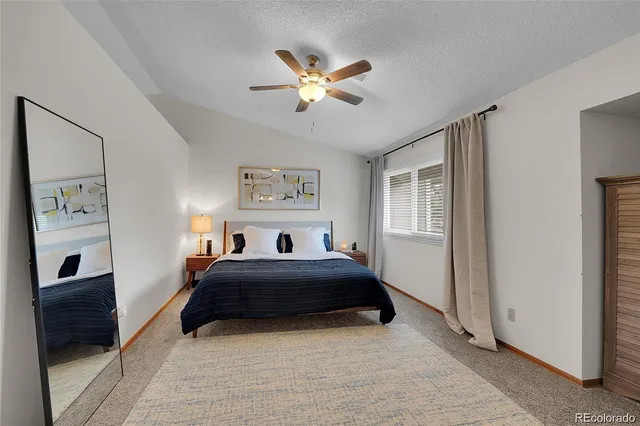 a bedroom with a bed and a painting on the wall