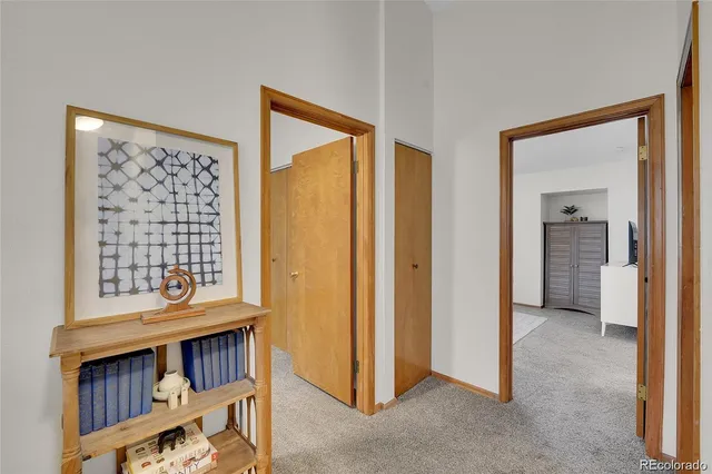 a view of an empty room with a window and a livingroom