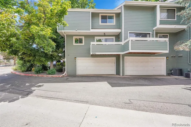 a front view of a house with a yard and a garage
