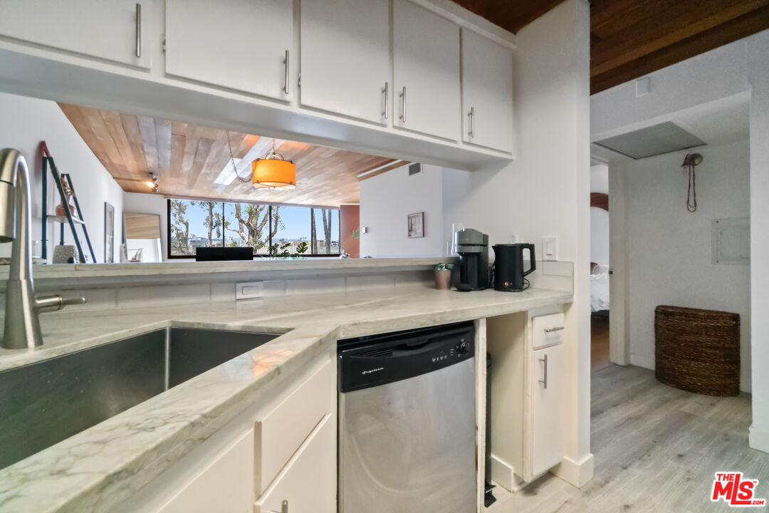 6209 Pacific Avenue, Unit 103 Playa del Rey, CA 90293 - Photo 19 of 40 a kitchen with stainless steel appliances granite countertop a sink and a stove