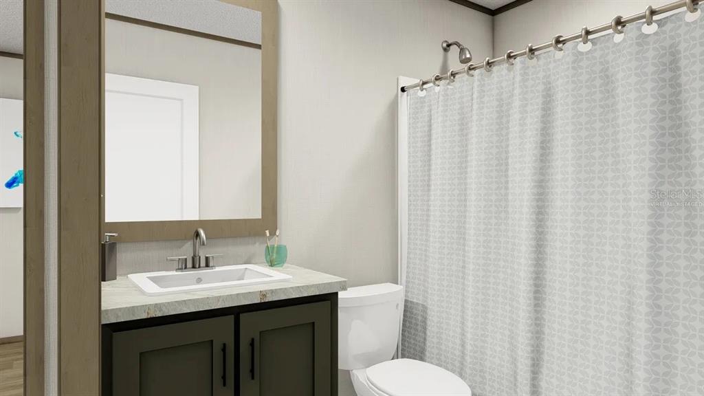 33242 Forest Ridge Road DeLand, FL 32720 - Photo 12 of 15 a bathroom with a sink a toilet and shower curtain