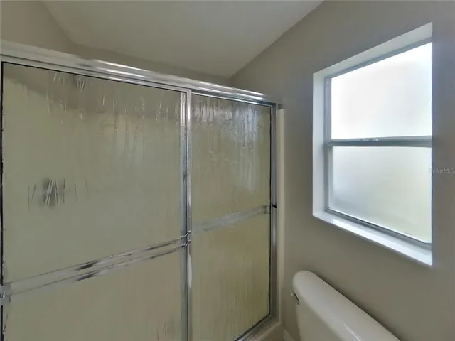 a bathroom with a glass shower door