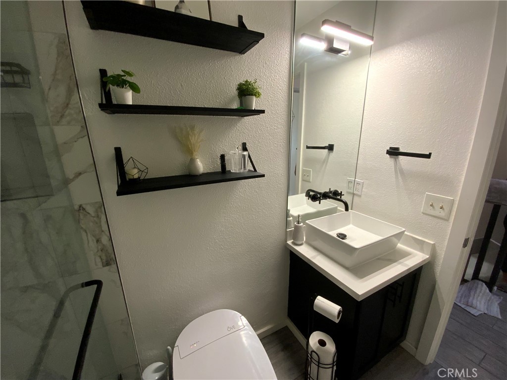 4140 Workman Mill Road, Unit 172 Whittier, CA 90601 - Photo 20 of 21 a bathroom with a sink a toilet and a mirror
