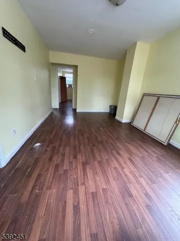 a view of a room with wooden floors and stairs