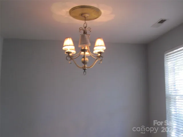 view of a chandelier fan and a window