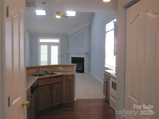 a kitchen with a stove and a wooden cabinets