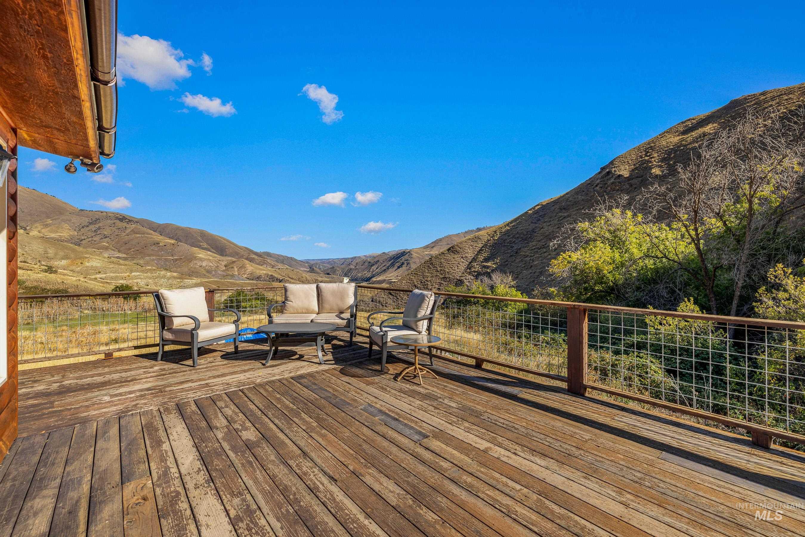 236 Seven U Ranch Road Lucile, ID 83542 - Photo 19 of 26 Deck with a mountain view and an outdoor hangout area