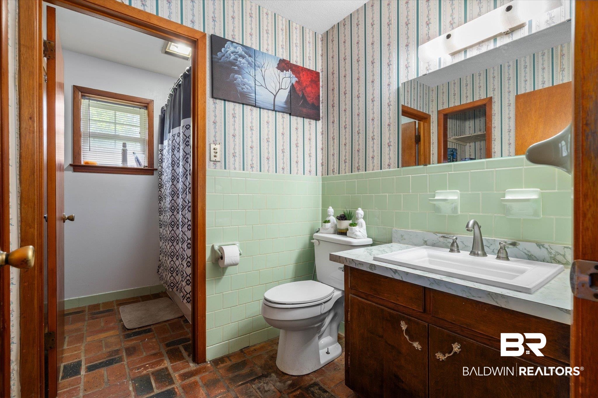 11601 Lott Road Chunchula, AL 36521 - Photo 11 of 34 Bathroom with vanity, tile walls, wallpapered walls, a shower with shower curtain, and wainscoting