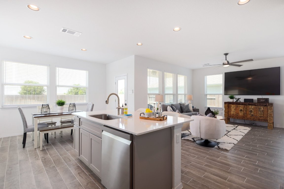 1408 Flint Knapper Drive Georgetown, TX 78626 - Photo 32 of 32 a living room with furniture a flat screen tv and a floor to ceiling window