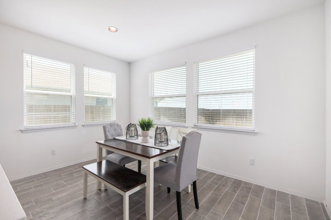 1408 Flint Knapper Drive Georgetown, TX 78626 - Photo 13 of 32 a view of a dining room with furniture and windows