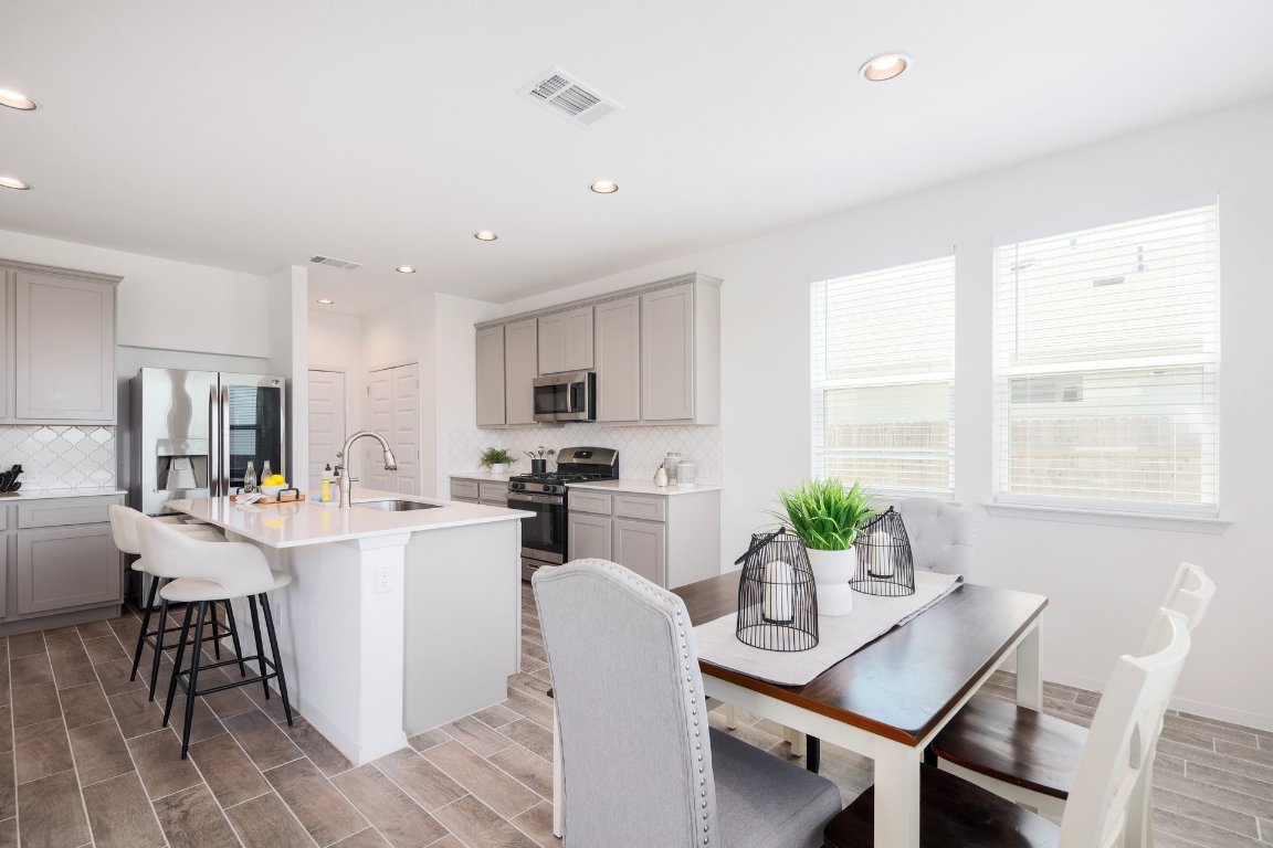 1408 Flint Knapper Drive Georgetown, TX 78626 - Photo 14 of 32 a view of a dining room with furniture window and wooden floor