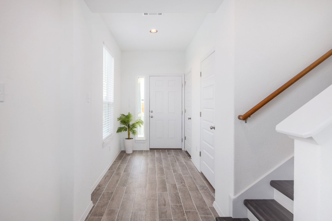 1408 Flint Knapper Drive Georgetown, TX 78626 - Photo 16 of 32 a view of a hallway with wooden floor and staircase