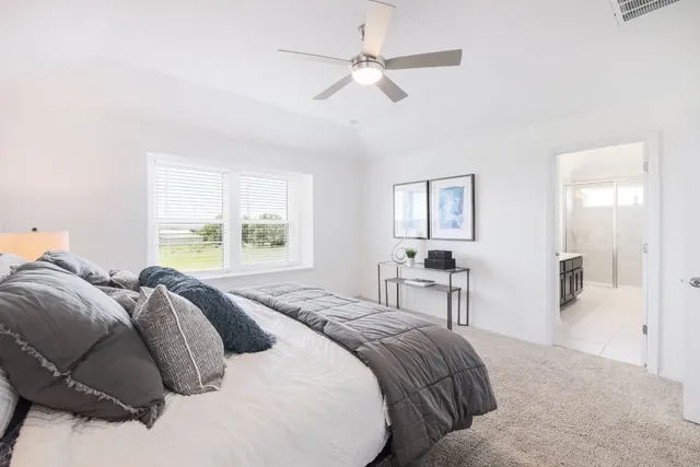 a spacious bedroom with a bed and window