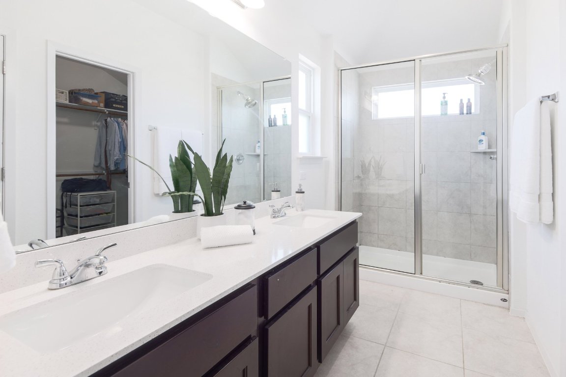1408 Flint Knapper Drive Georgetown, TX 78626 - Photo 21 of 32 a bathroom with a double vanity sink mirror and shower