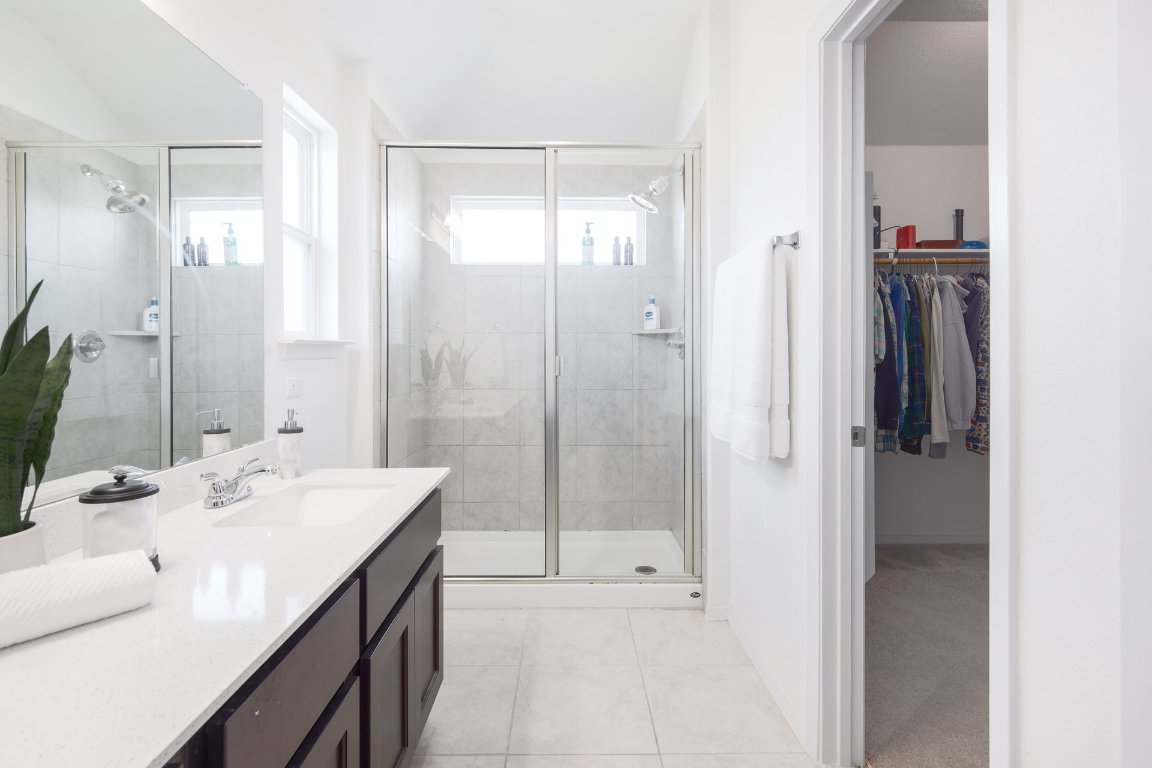 1408 Flint Knapper Drive Georgetown, TX 78626 - Photo 22 of 32 a bathroom with a tub sink and mirror