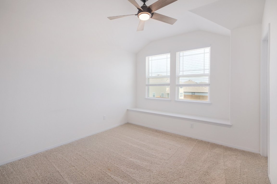 1408 Flint Knapper Drive Georgetown, TX 78626 - Photo 23 of 32 an empty room with a window and a fan