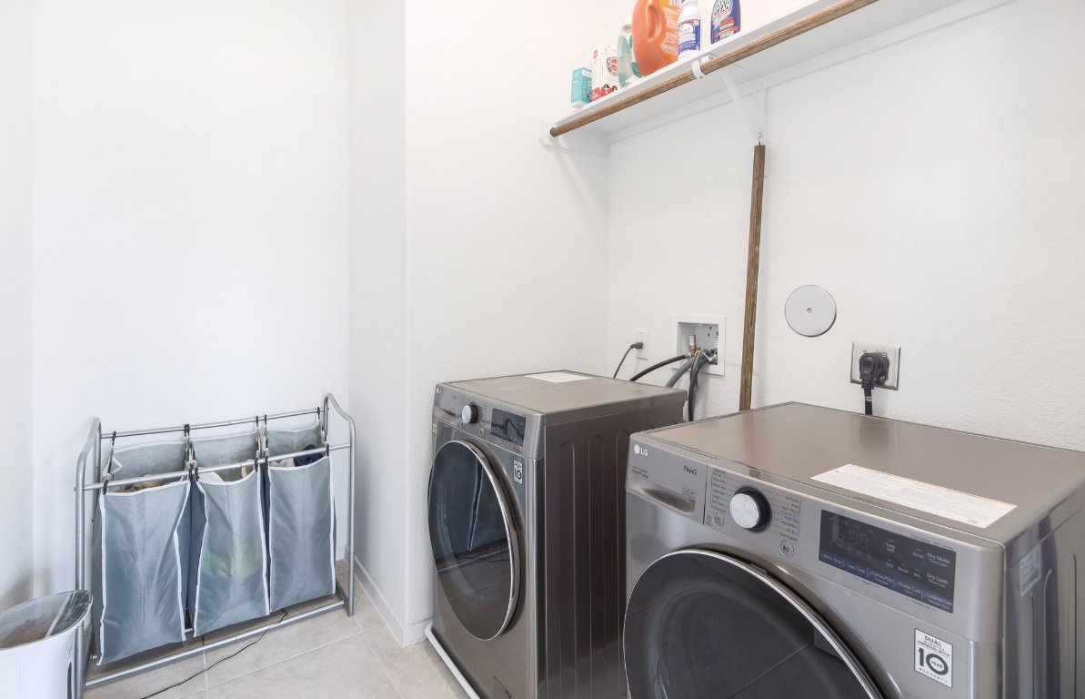 1408 Flint Knapper Drive Georgetown, TX 78626 - Photo 26 of 32 a utility room with dryer and washer