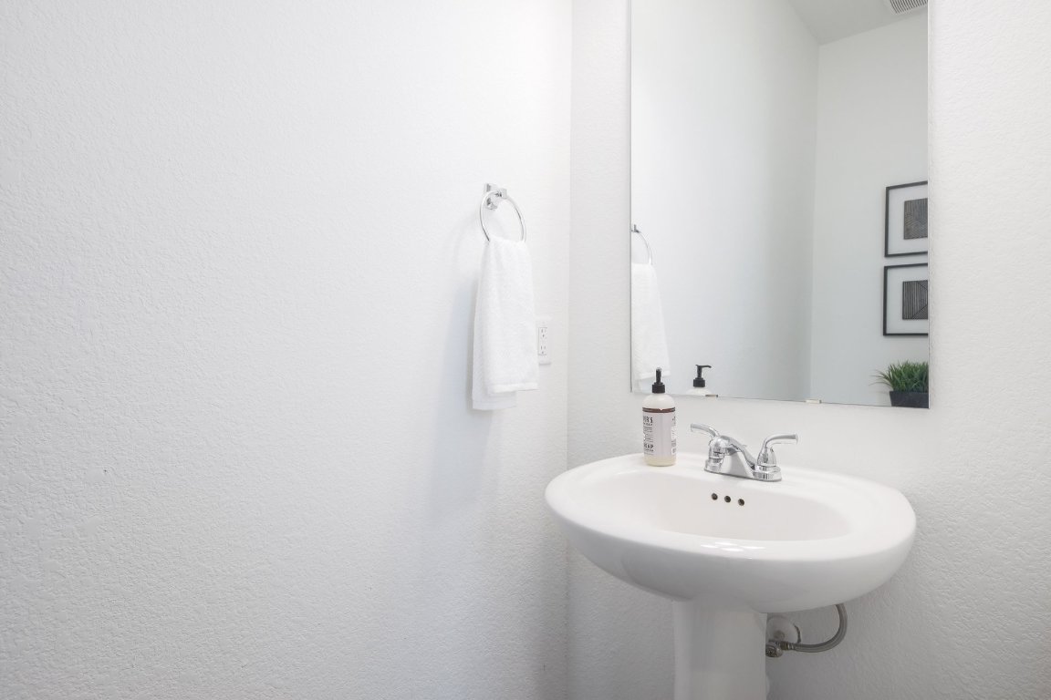 1408 Flint Knapper Drive Georgetown, TX 78626 - Photo 27 of 32 a bathroom with a sink and a mirror