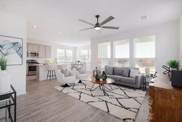 a living room with furniture and kitchen view