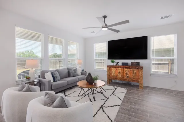 a living room with furniture and a flat screen tv