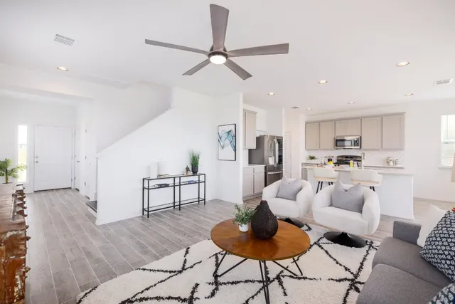a living room with furniture and kitchen view