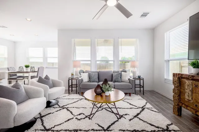 a living room with furniture and a large window