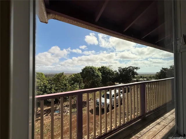 a view of balcony with wooden floor and fence