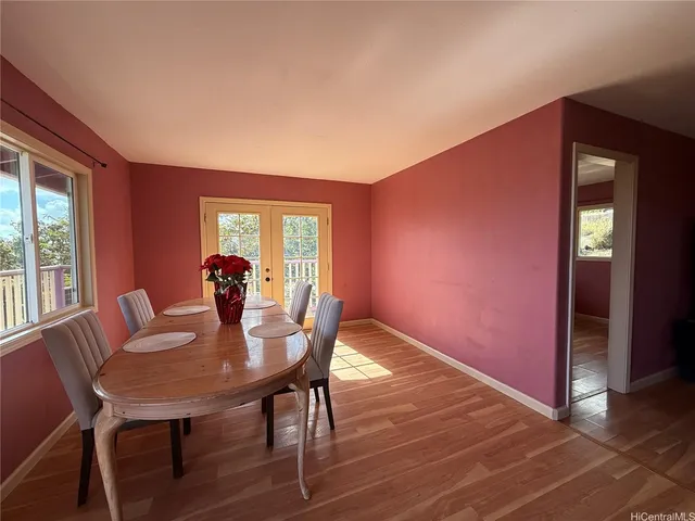 a kitchen with granite countertop wooden floors a sink and a window