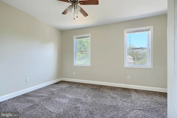 a view of room with window and ceiling fan