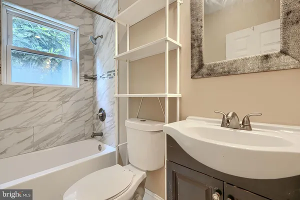 a bathroom with a sink toilet and bathtub