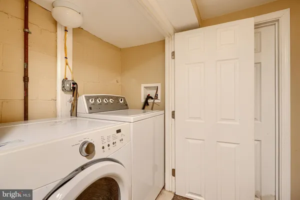 a bathroom with a sink a toilet a mirror and shower