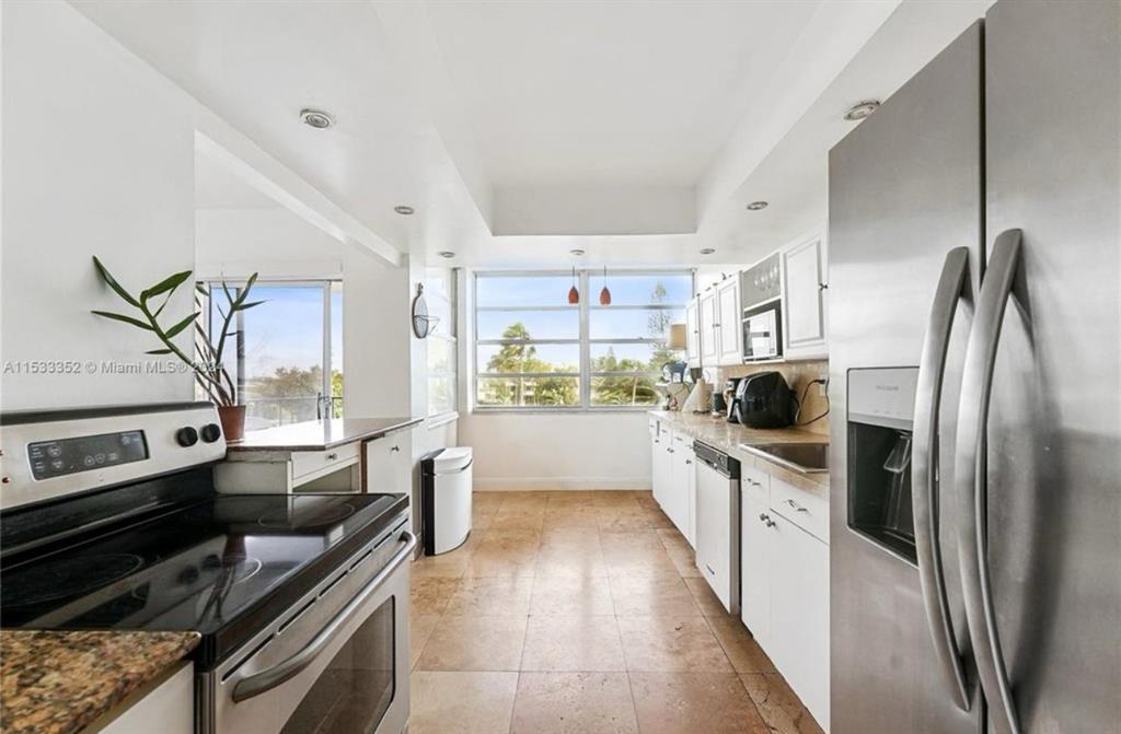 a kitchen with stainless steel appliances a stove a sink and a refrigerator