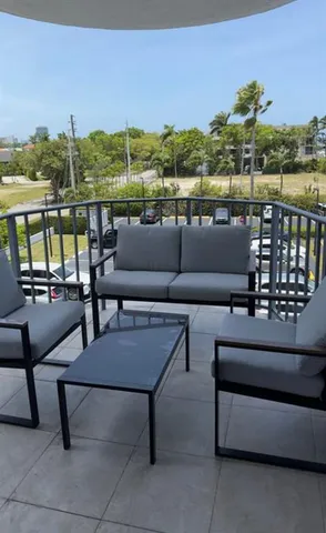a roof deck with couches and potted plants