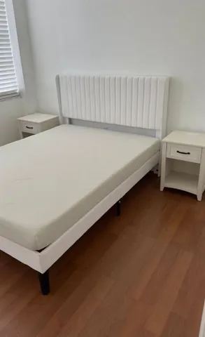 a spacious bathroom with a bed and a window